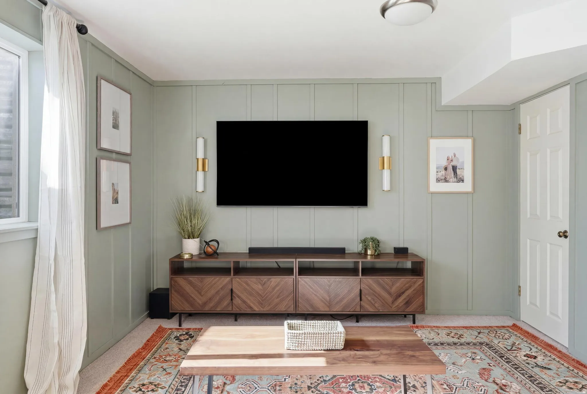 Vertical paneling accent wall with sconce lighting
