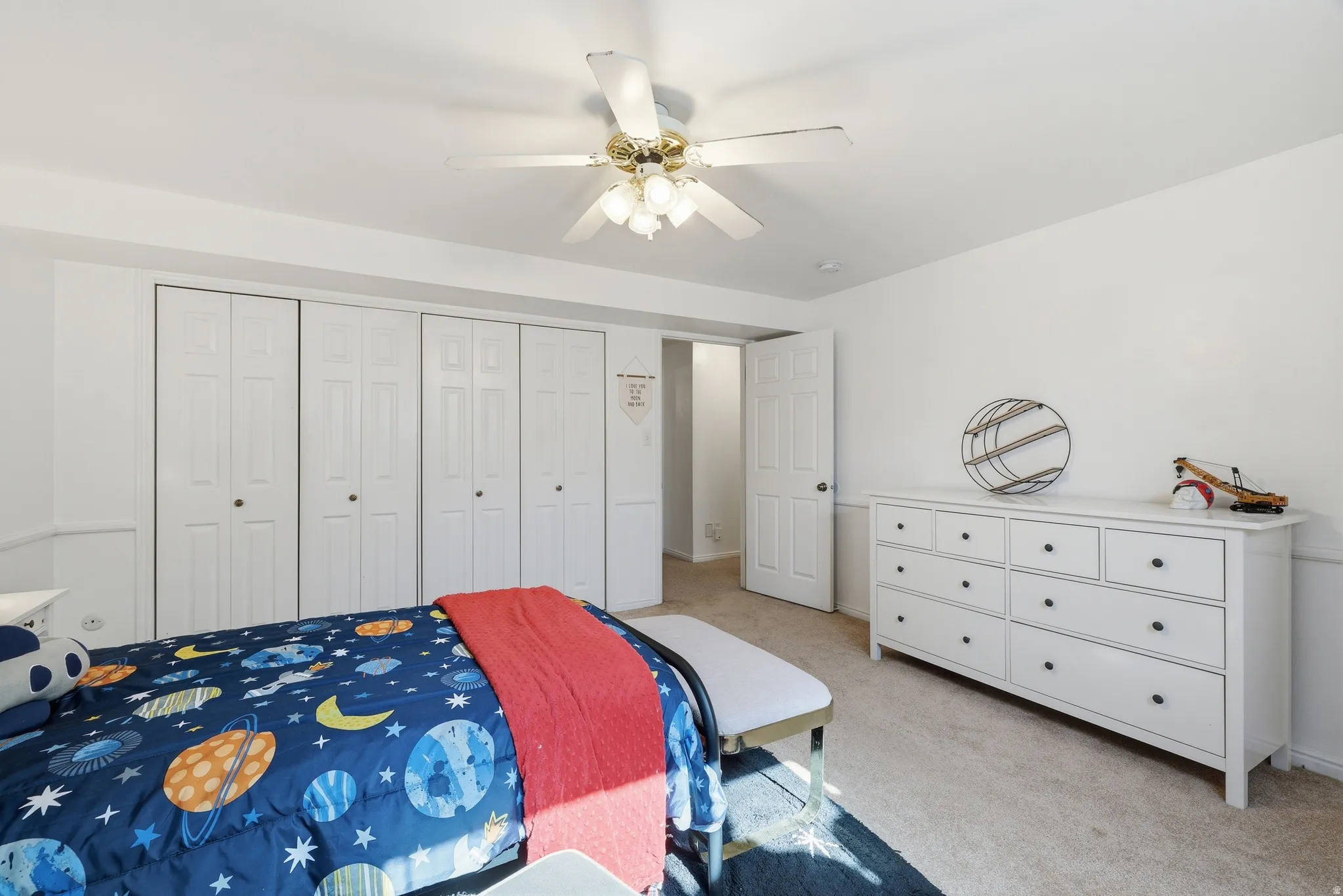 White walls and light-toned carpet create a bright interior