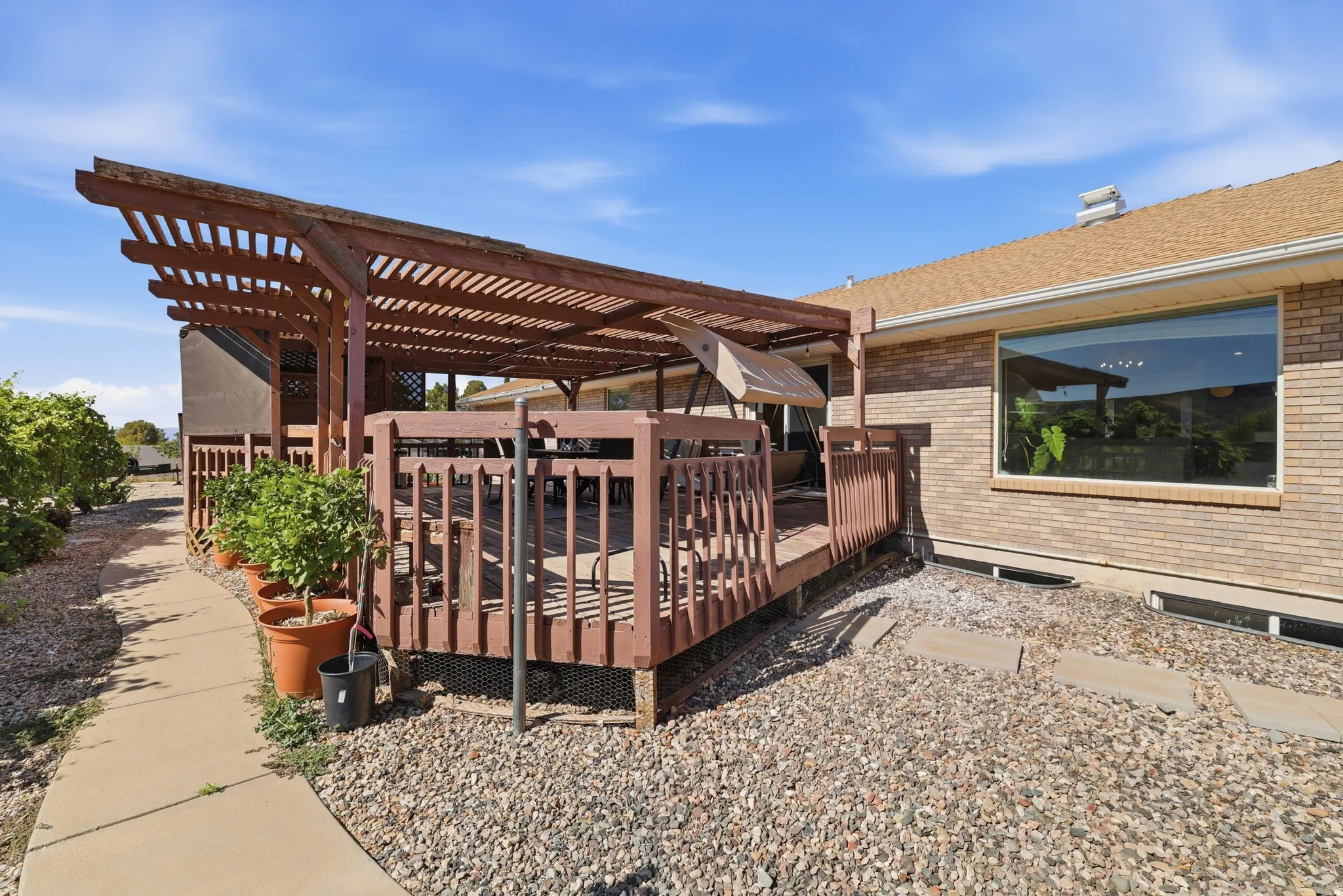 Expansive wood deck with a slatted pergola overhead