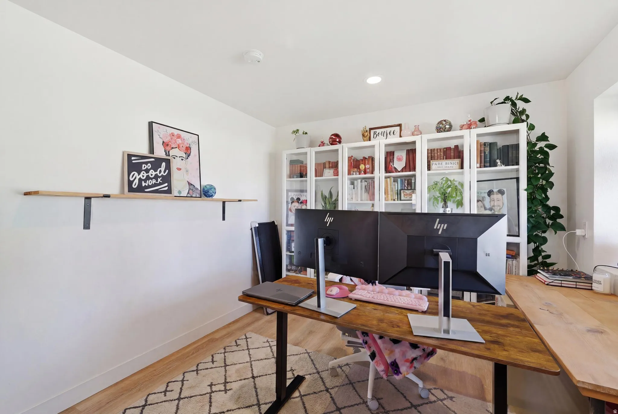 Dedicated office space featuring wood-finish flooring and white painted walls