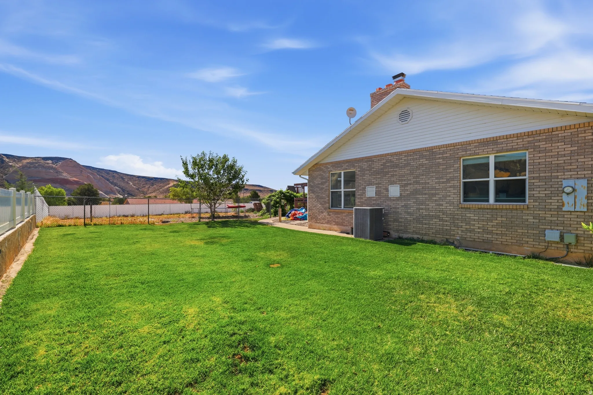Expansive green lawn with mountain backdrop