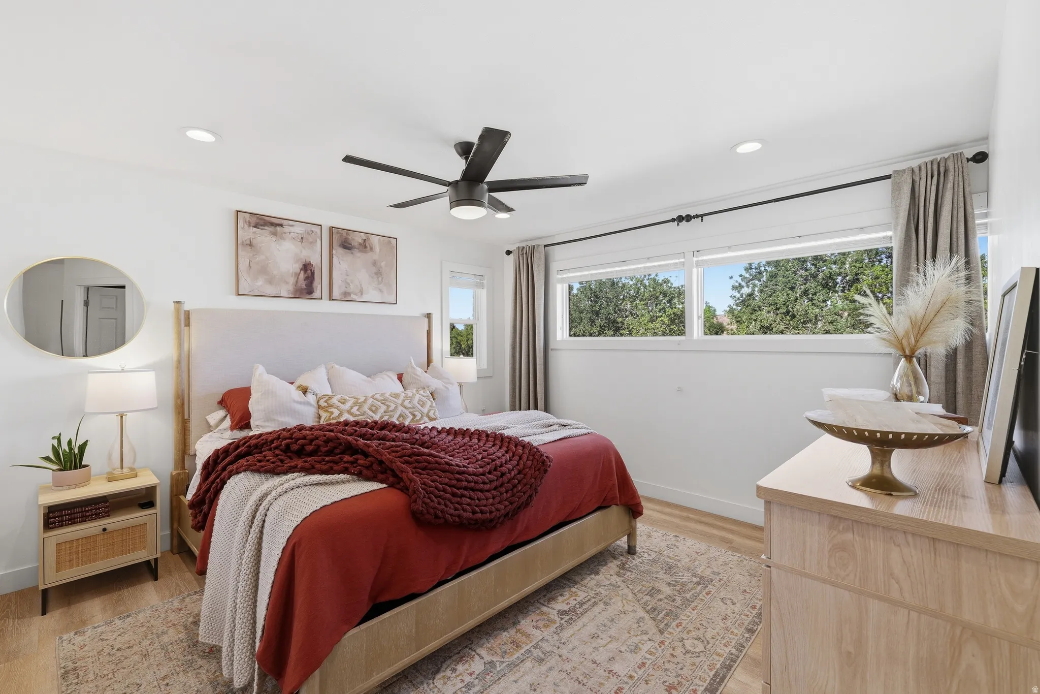 Light wood-finish flooring complements white walls and recessed lighting