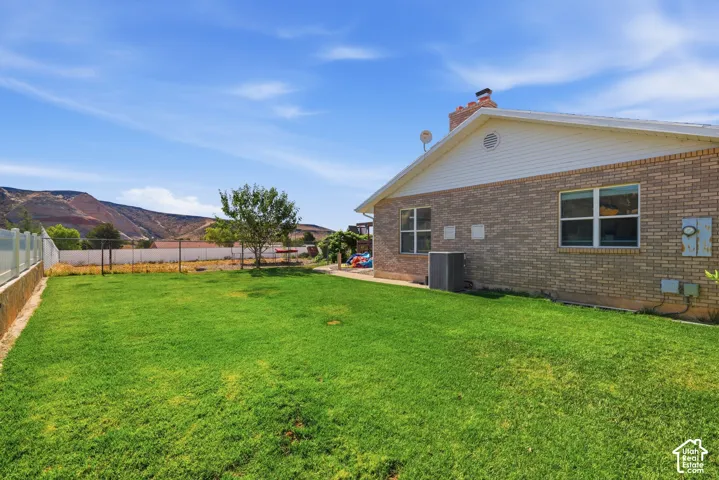 Expansive green lawn with mountain backdrop