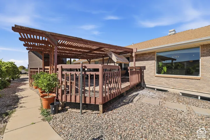 Expansive wood deck with a slatted pergola overhead