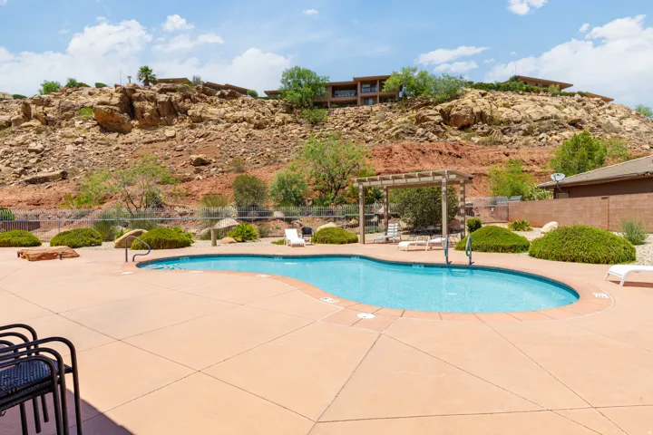 Curved swimming pool with an integrated entry, surrounded by a concrete pool deck