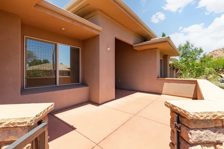 Stucco exterior with stone accents and a covered entry