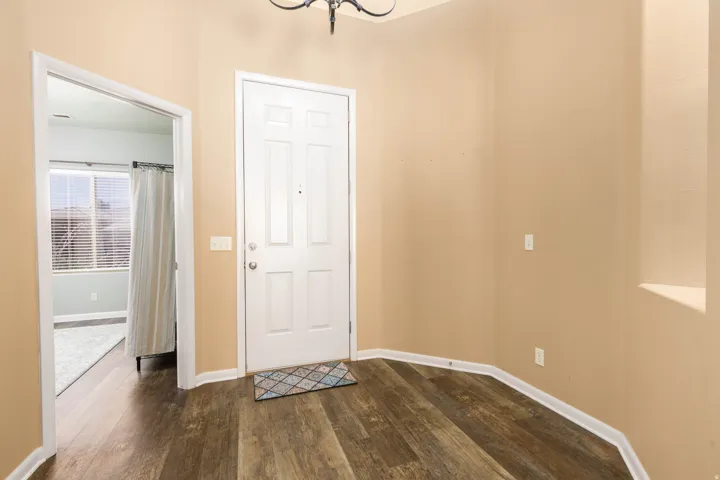 Entryway featuring wood-finish flooring and neutral wall tones