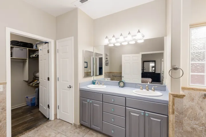 Dual vanity with light gray cabinetry, light blue countertop, and undermount sinks