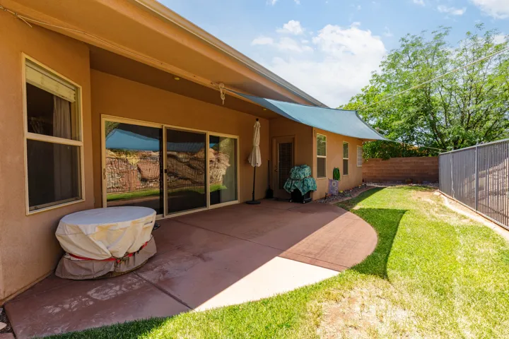 Expansive rear concrete patio featuring direct access to the interior via sliding glass doors