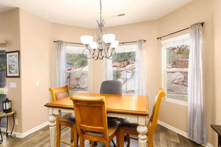 Dining area with wood-finish flooring and neutral wall tones