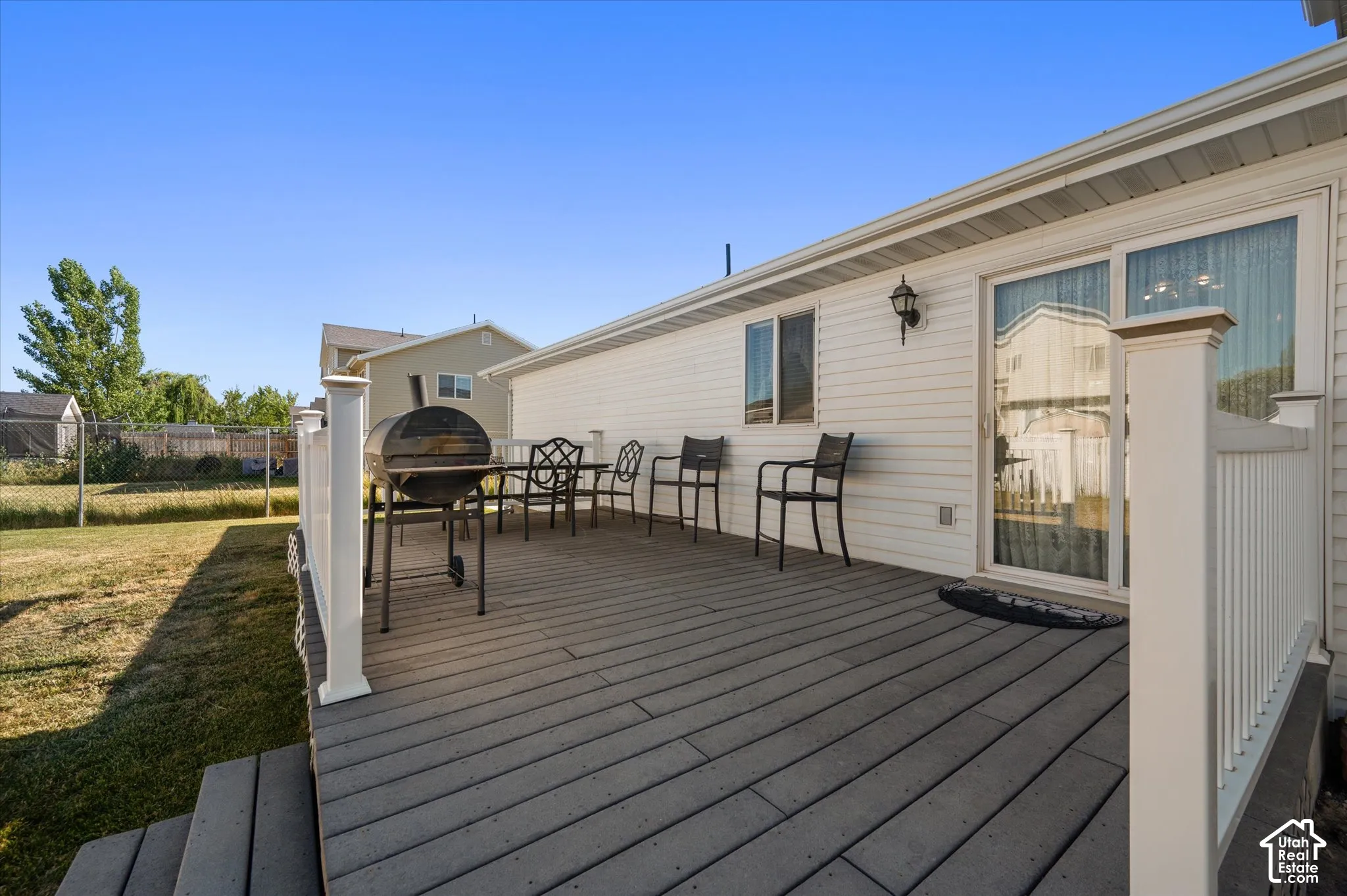 Expansive composite deck with white railing, directly accessible via sliding glass doors
