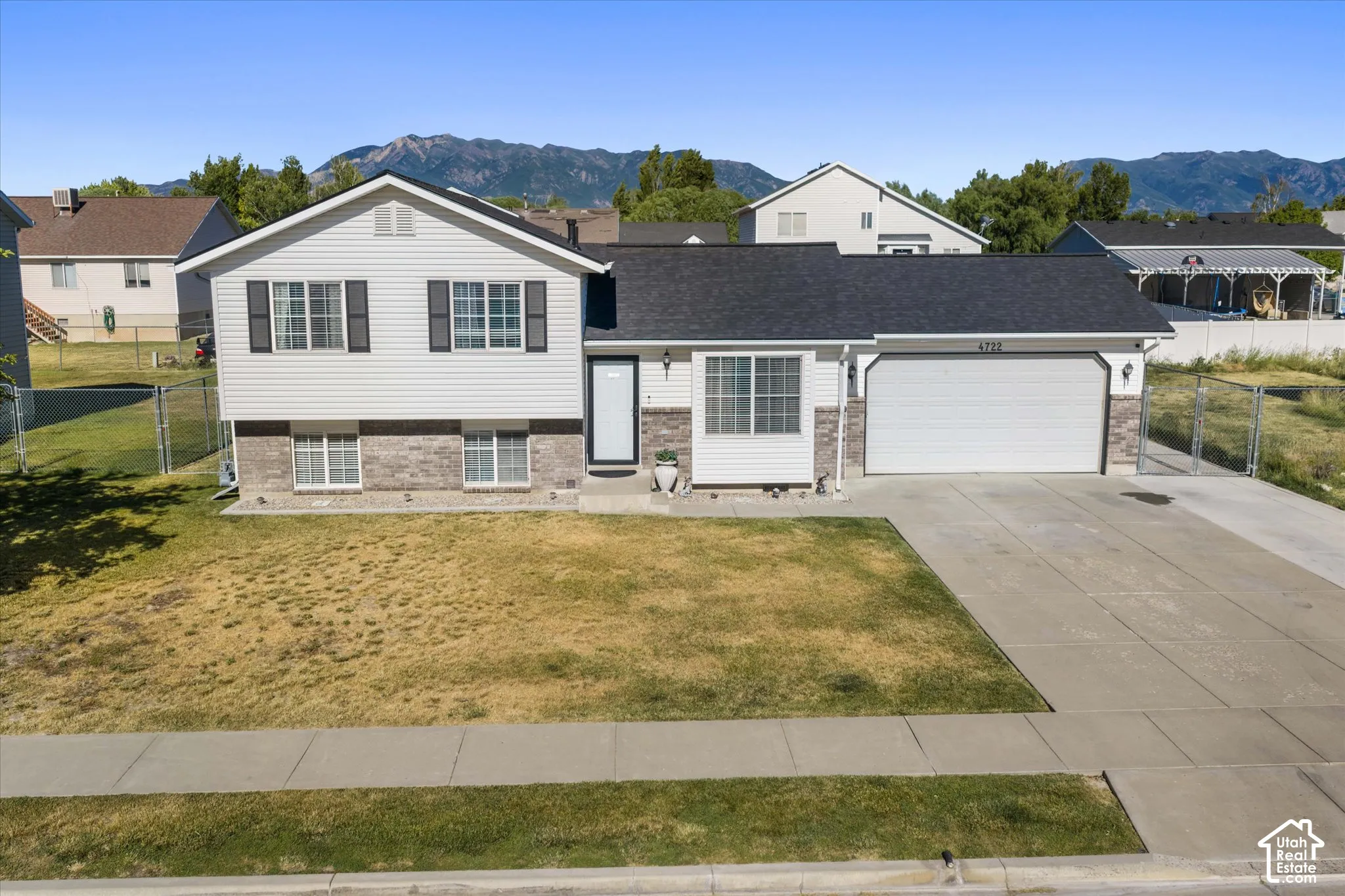 Split-level residence featuring white siding and a dark roof. Roof is brand new!