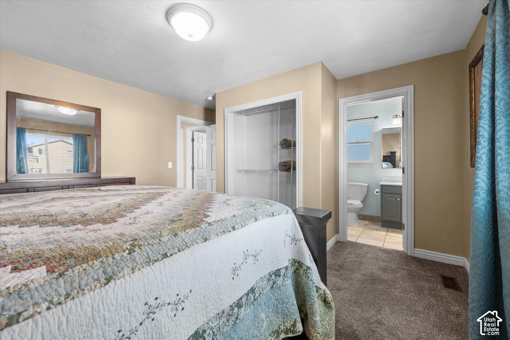 Bedroom featuring neutral wall color, textured carpeting, and a ceiling-mounted light fixture