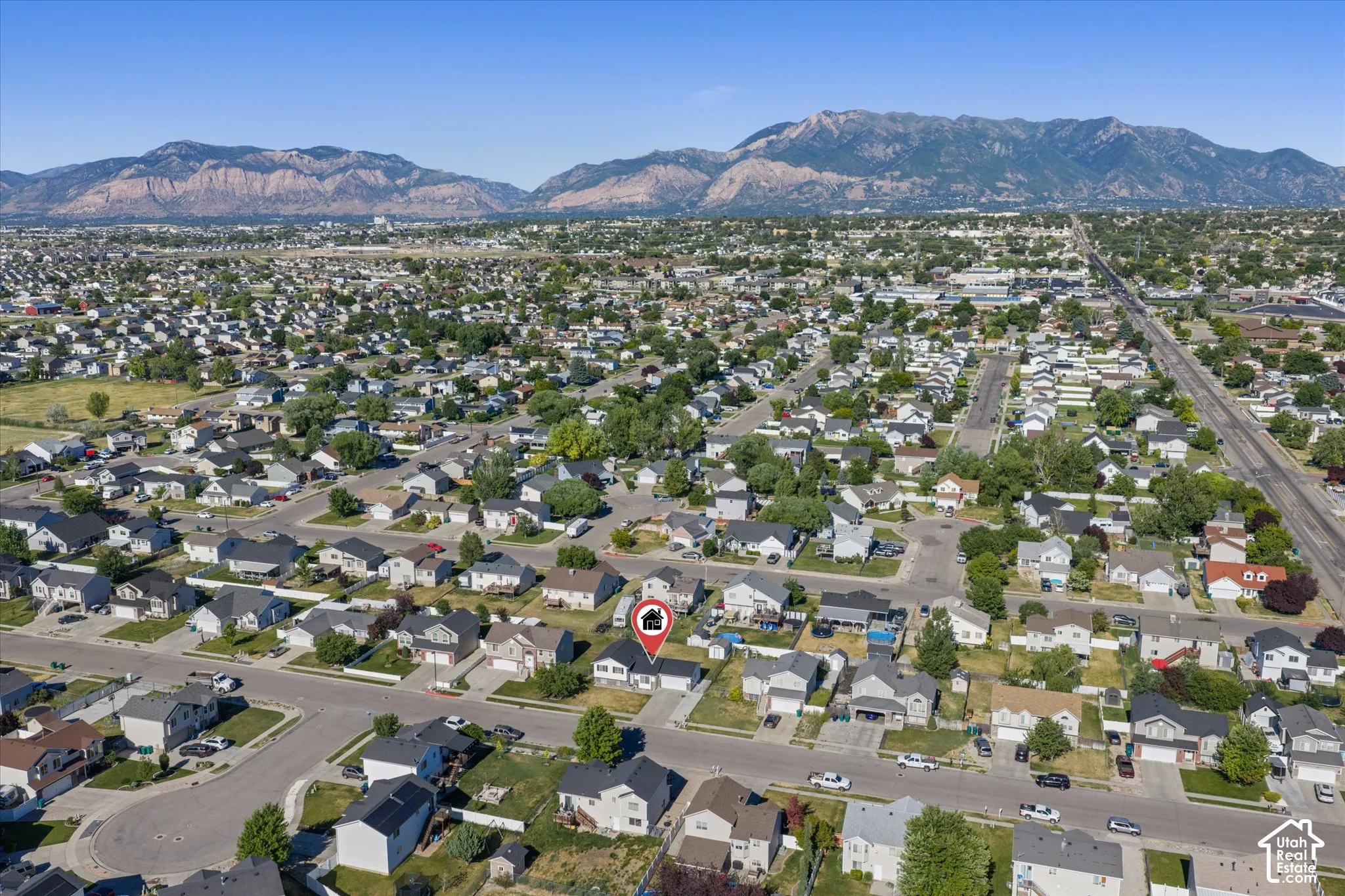 Aerial perspective showcasing the residential neighborhood with a distant mountain range backdrop
