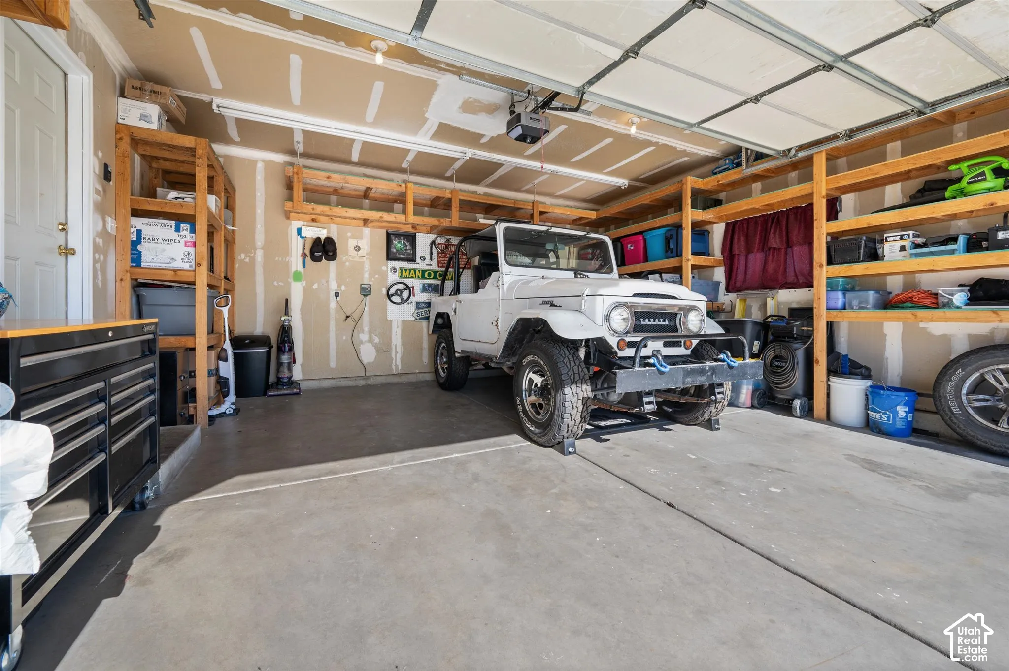 Spacious garage featuring concrete flooring and an automatic overhead door
