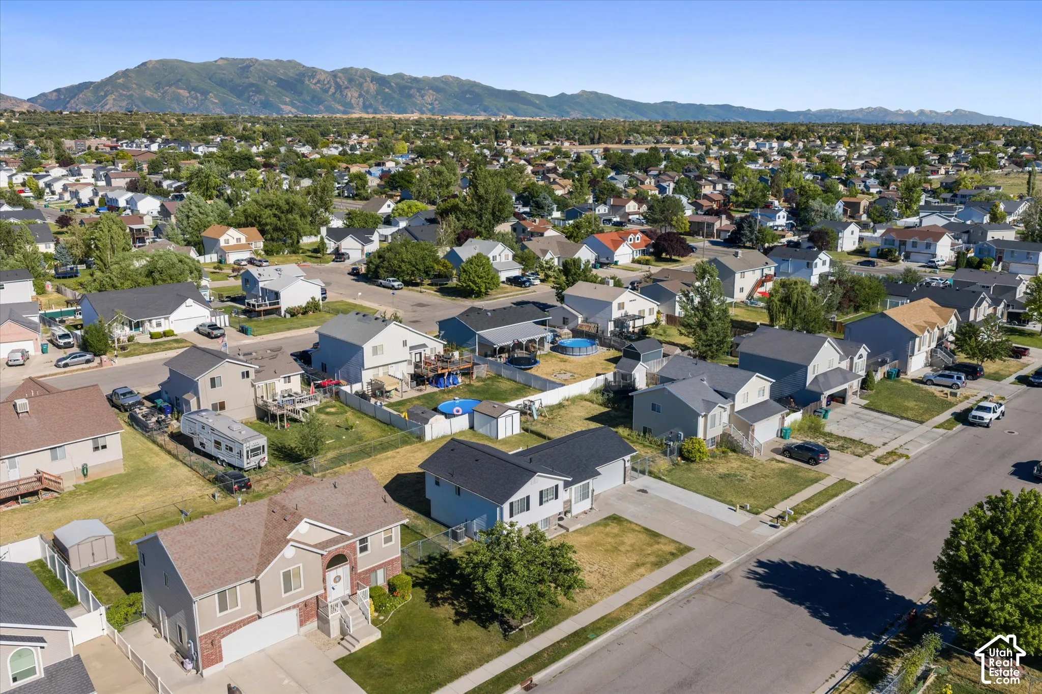 Residential development featuring a variety of architectural styles, established landscaping, and paved streets
