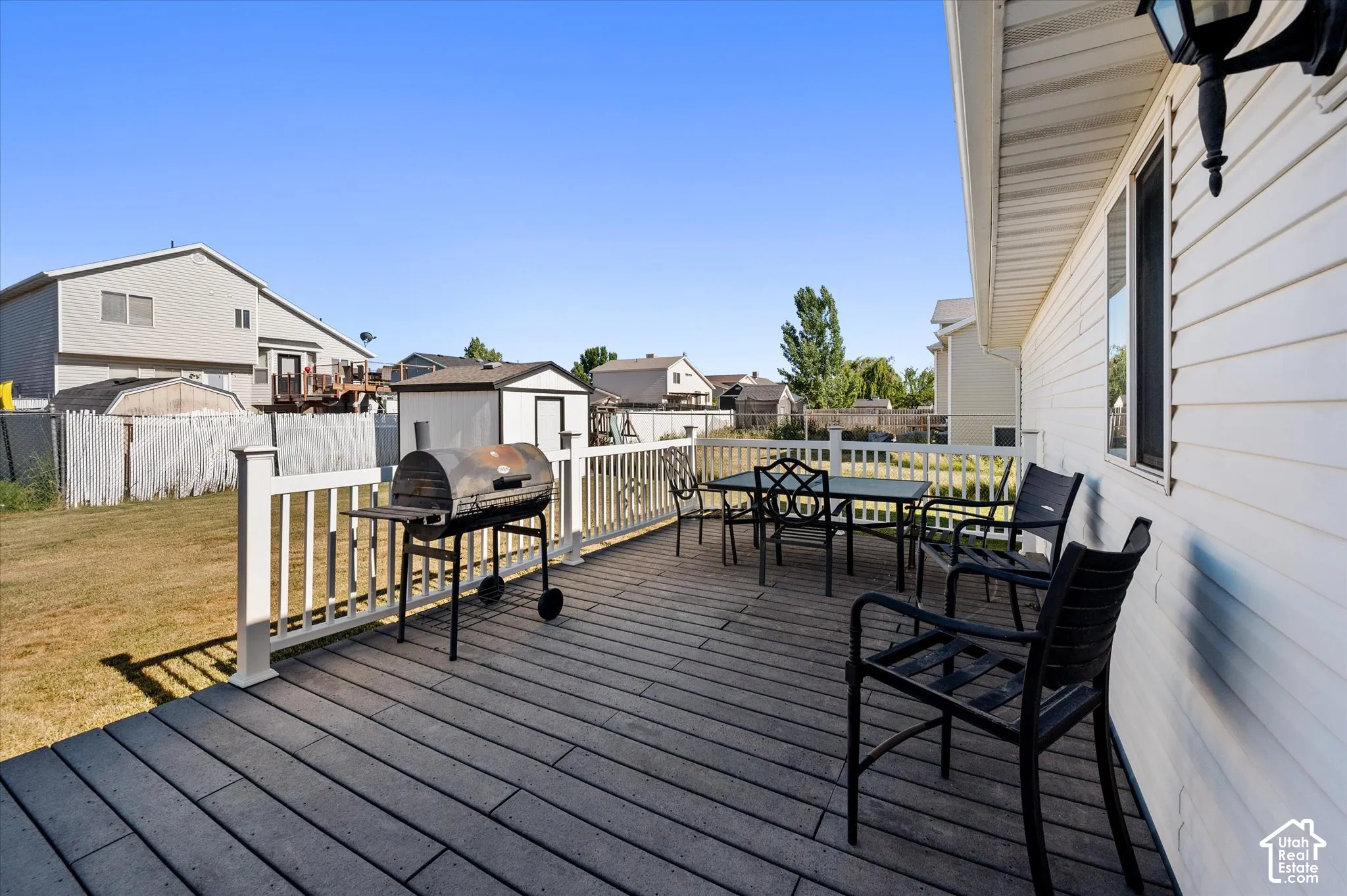 Expansive outdoor deck featuring composite decking and white railings