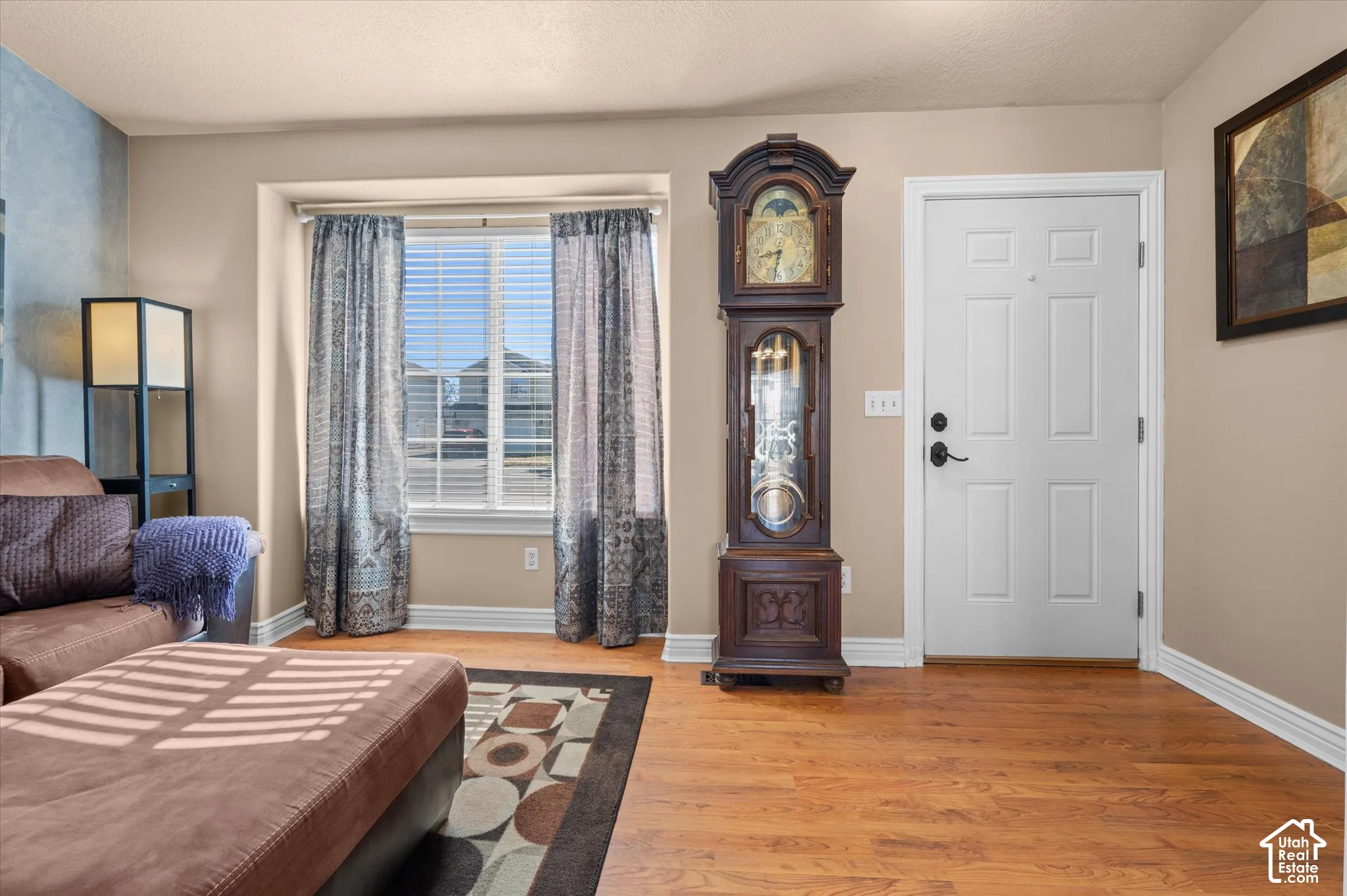 Warm wood-finish flooring complements the neutral wall color
