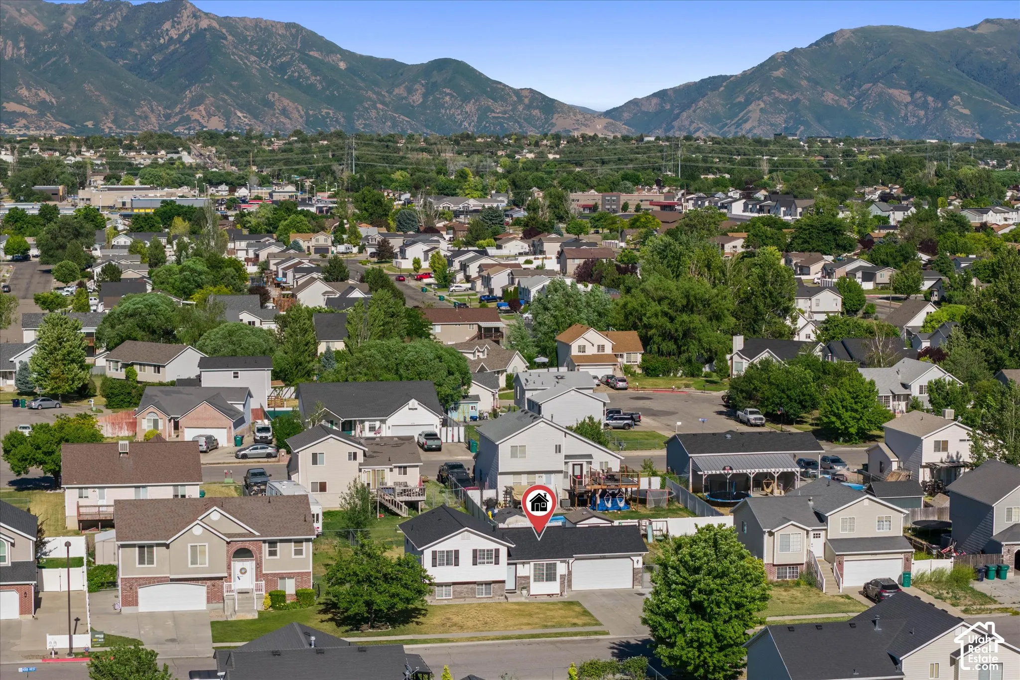 Suburban neighborhood setting with residential structures and mature trees