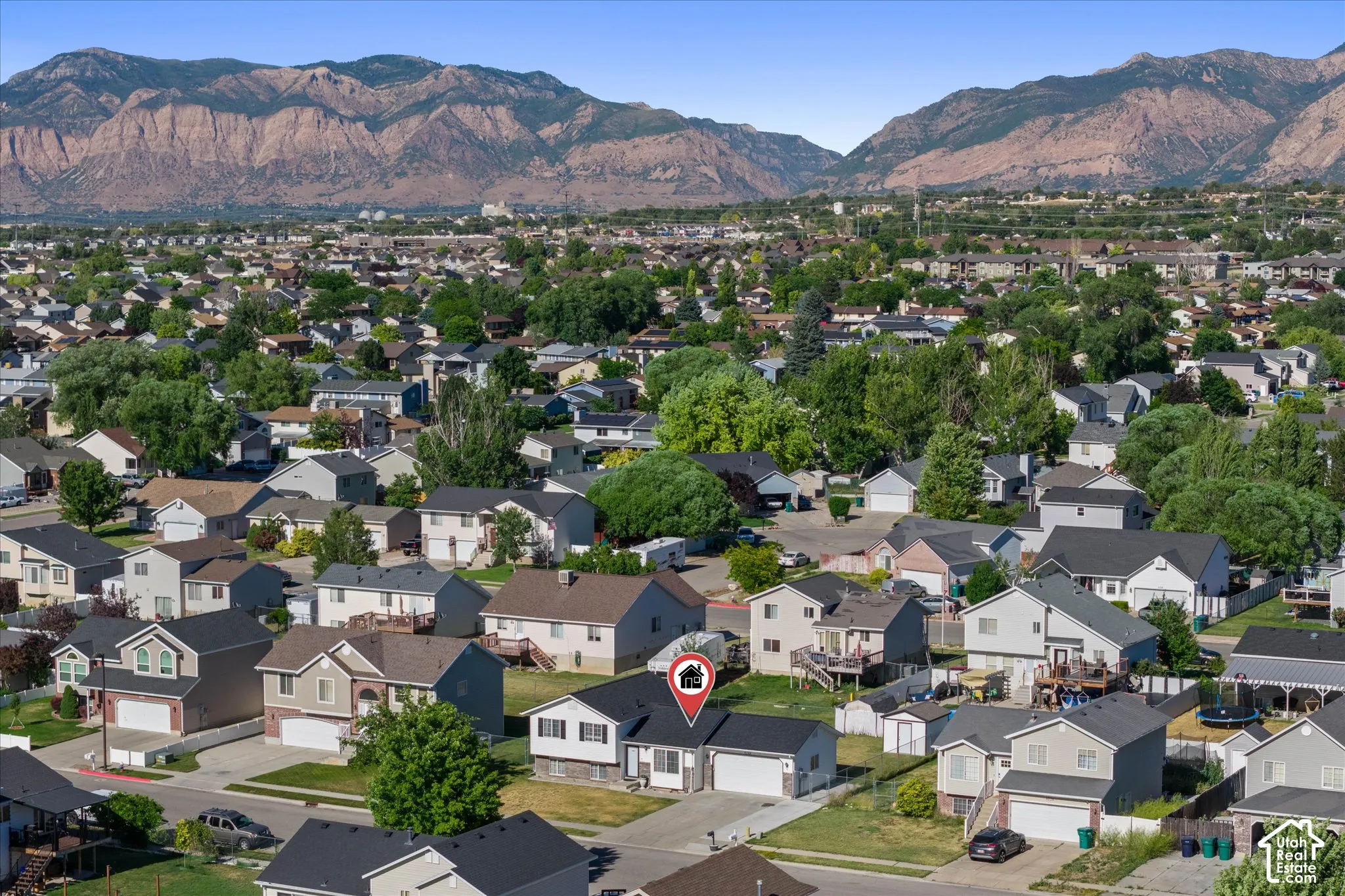 Aerial perspective showcasing a residential neighborhood with distant mountains