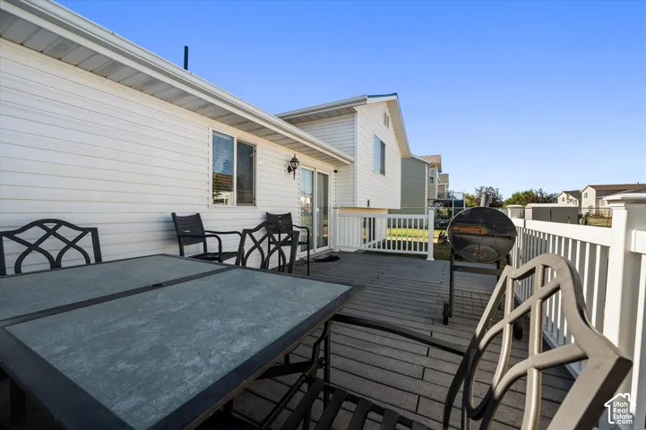 Spacious outdoor deck featuring gray composite decking and white railings