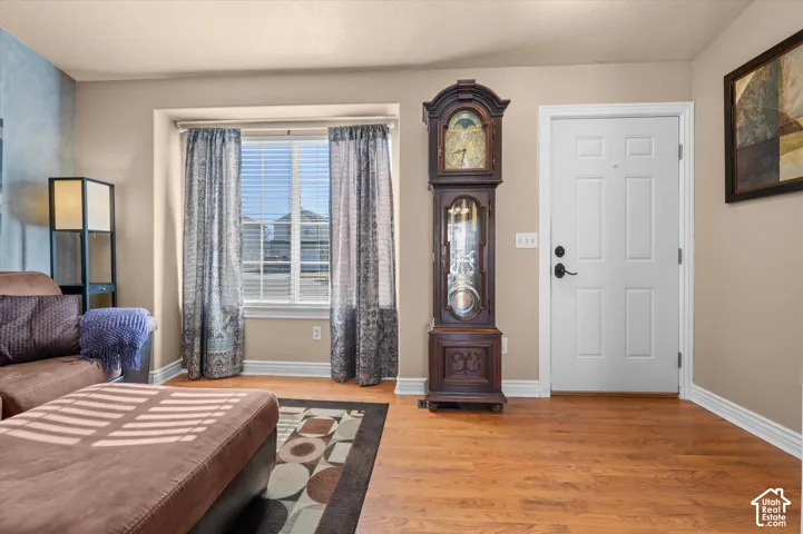 Warm wood-finish flooring complements the neutral wall color