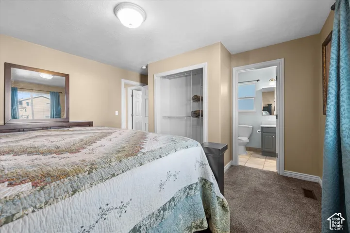 Bedroom featuring neutral wall color, textured carpeting, and a ceiling-mounted light fixture