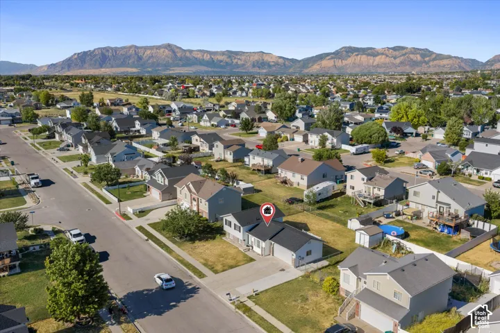 Neighborhood setting featuring a single-family residence with a two-car garage, concrete driveway, and front lawn