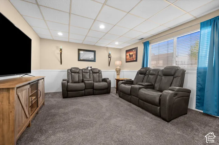 Carpeted room featuring a drop ceiling with recessed lighting