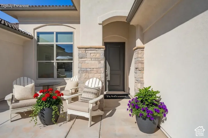 Arched entryway featuring a paneled door, stone facade accents, and stucco exterior