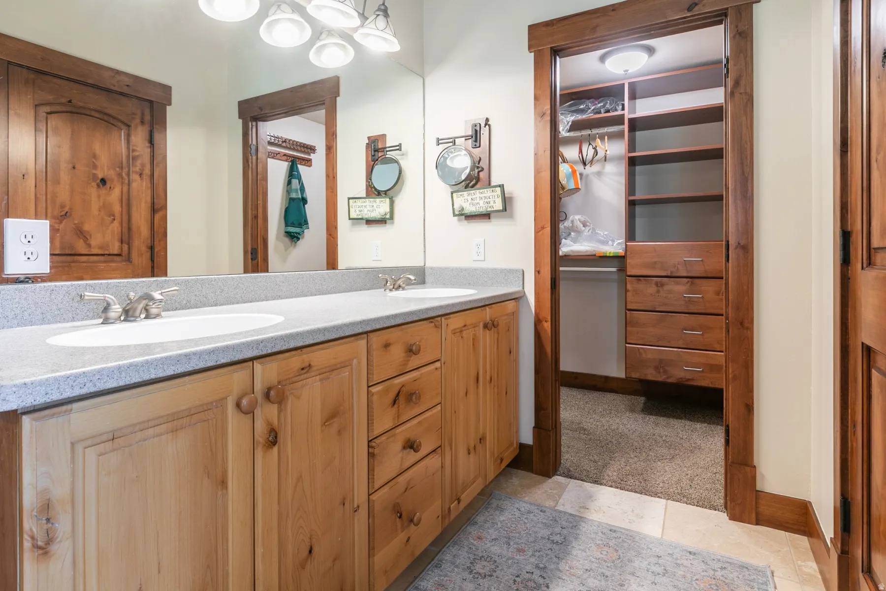 Double vanity with light-colored countertops and wood-finish cabinetry