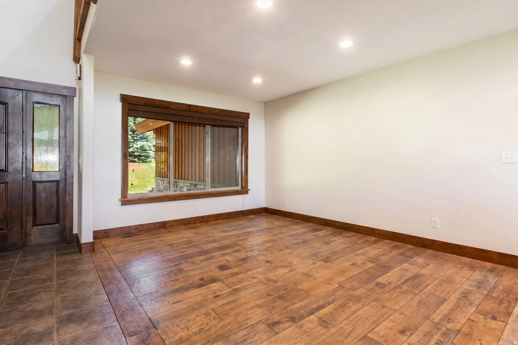 Foyer area featuring dark wood-finish double entry doors with glass inserts