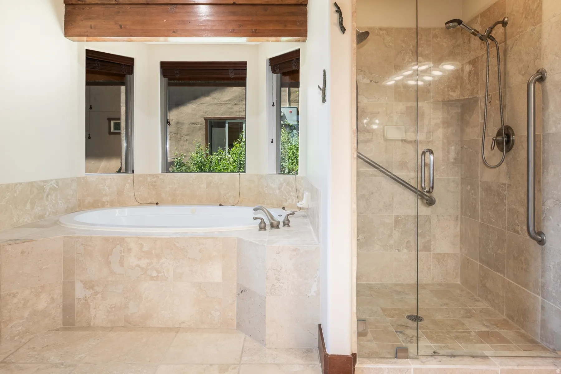 Jetted soaking tub and walk-in shower with glass enclosure