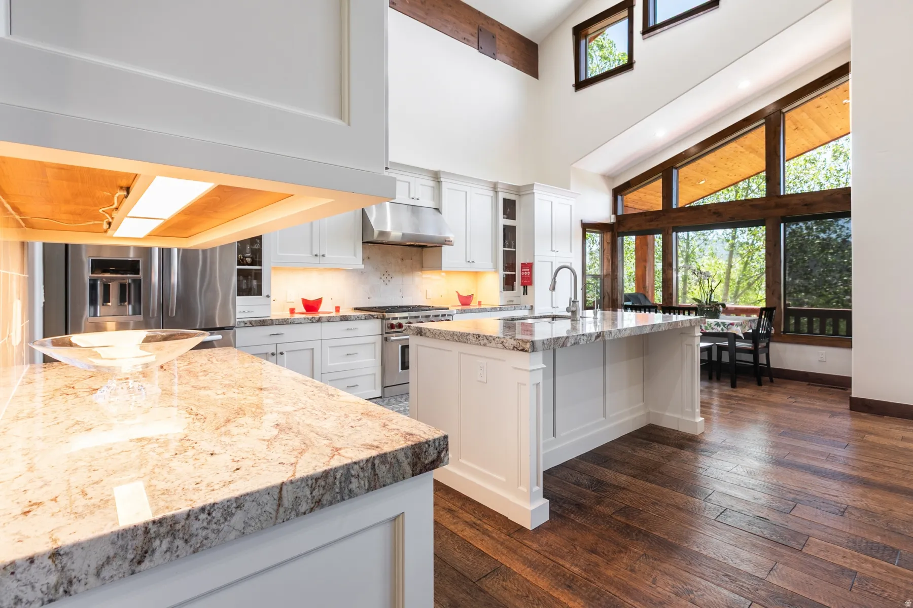 Gourmet kitchen featuring white cabinetry, granite countertops, and stainless steel appliances