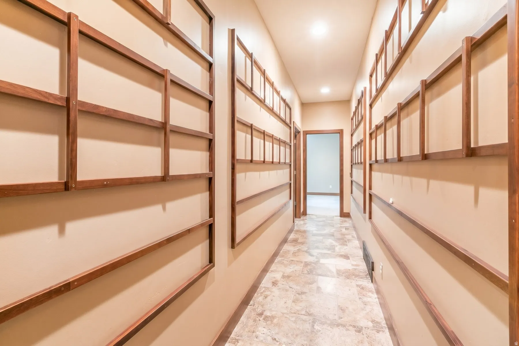 Hallway with neutral tone walls and decorative wood framing