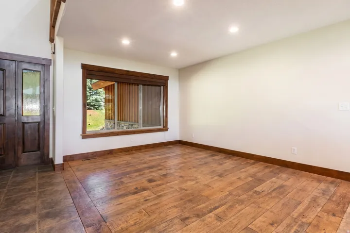 Foyer area featuring dark wood-finish double entry doors with glass inserts
