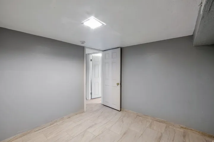 Neutral gray walls complement the light-toned tile flooring