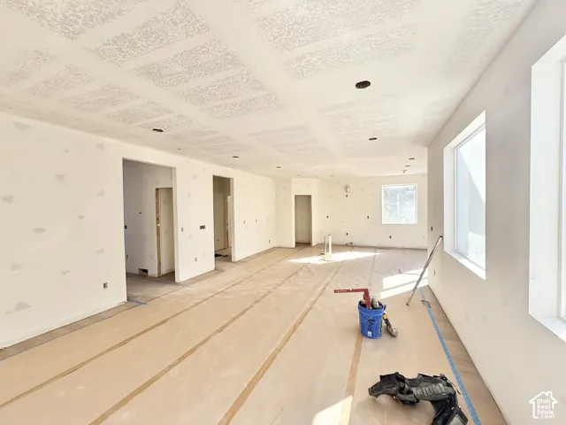 Expansive interior space with multiple windows, recessed ceiling lighting, and multiple doorways