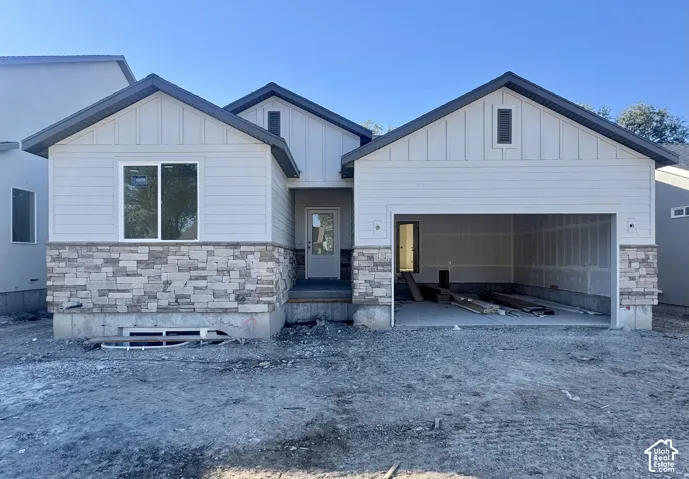 Exterior complete as of 10/7/26 - Sandstone color garage door ordered to match the taupe colors in the stone work