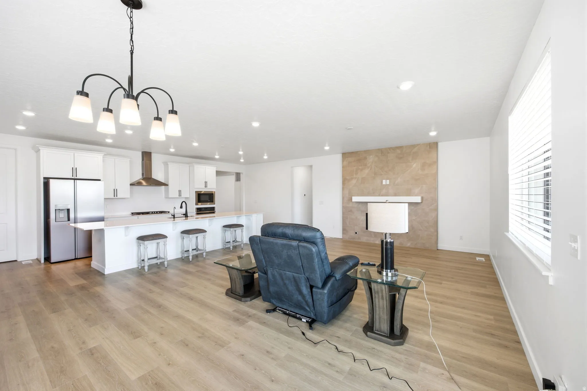 Open-concept living area featuring wood-finish flooring and recessed lighting