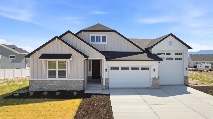 Modern farmhouse exterior featuring board and batten siding with stone accents