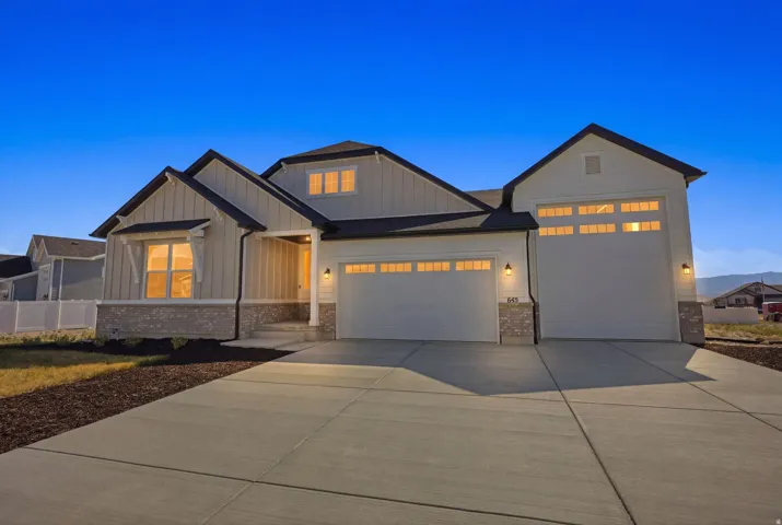 Contemporary farmhouse-style exterior featuring vertical board and batten siding, horizontal siding, and a stone veneer foundation