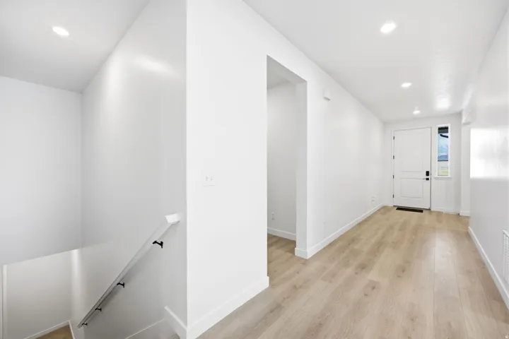 Entryway featuring light wood-finish flooring and recessed ceiling lighting