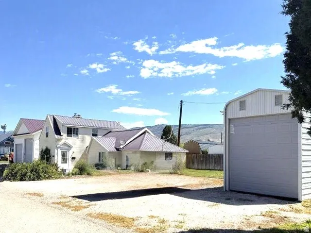 Two-story residence with a metal roof and a detached metal-sided garage