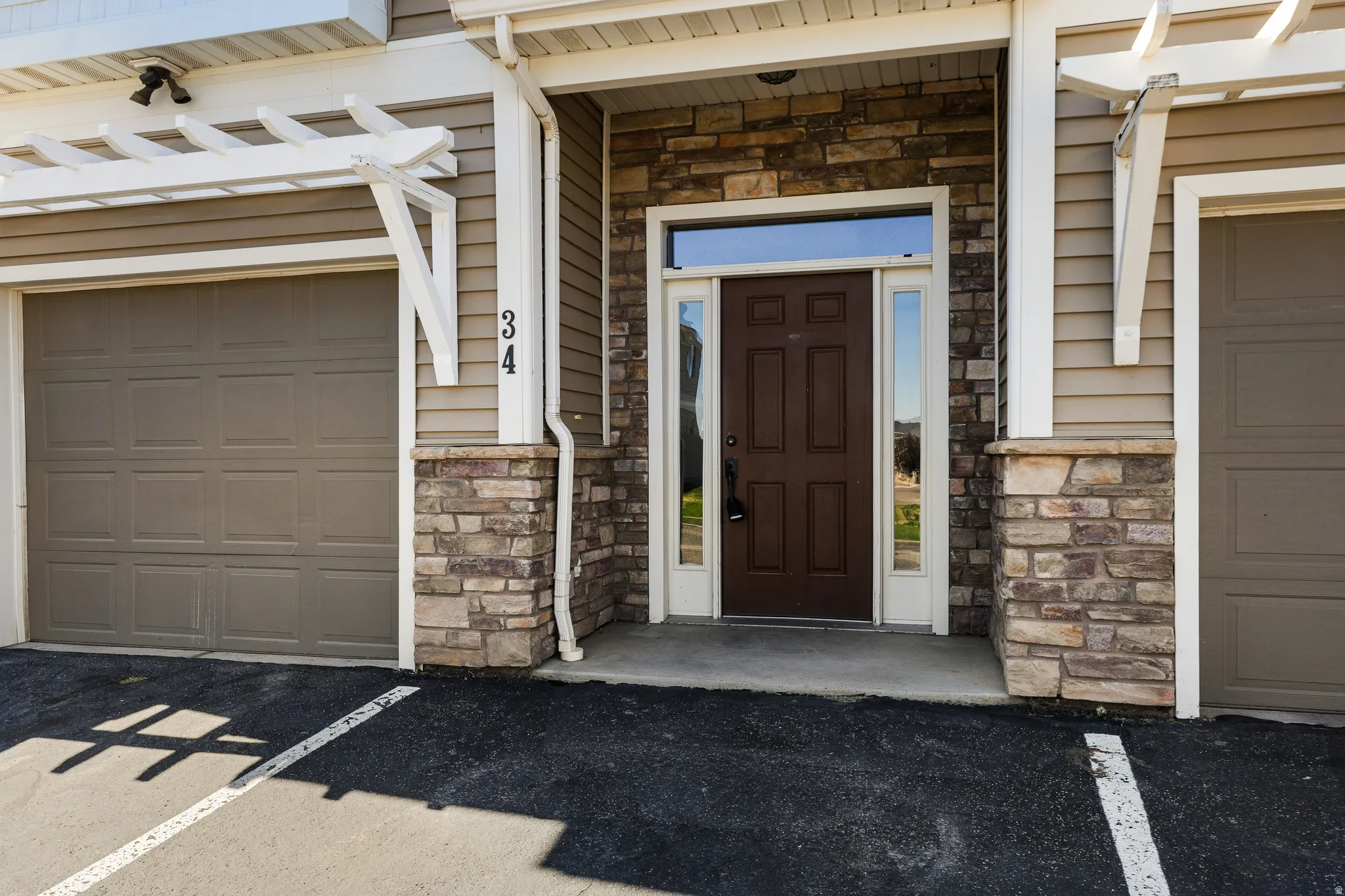 Exterior facade featuring stone veneer accents and horizontal siding