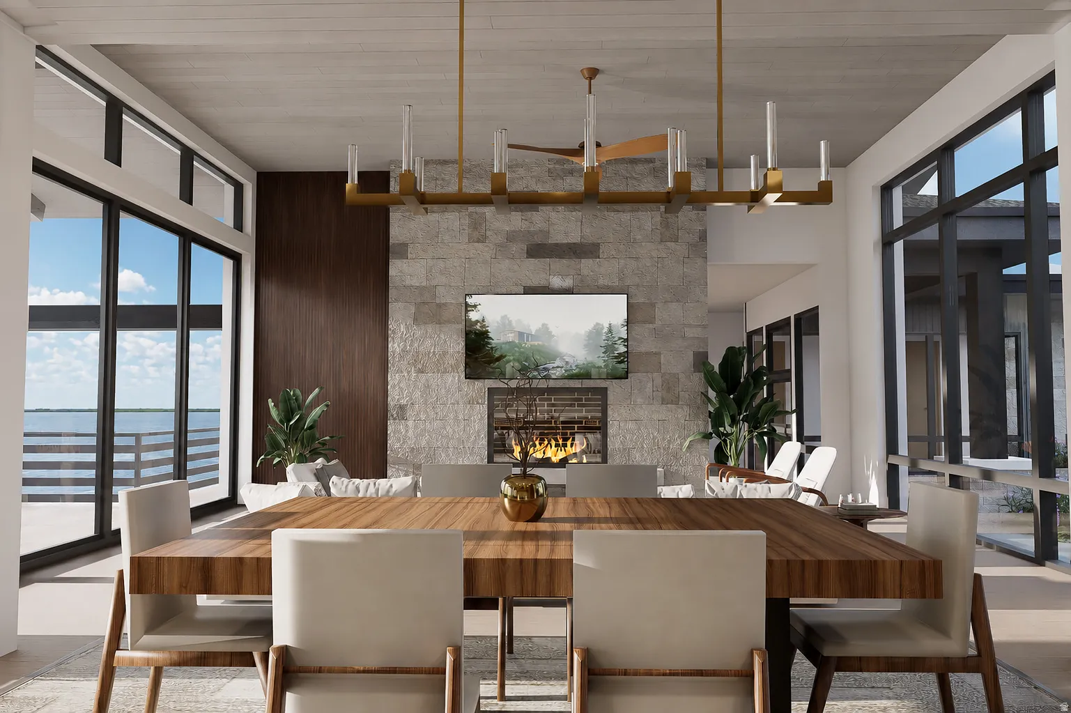 Spacious open-concept interior featuring a substantial wood-finish dining table, a stone-clad fireplace with a recessed television, and expansive sliding glass doors