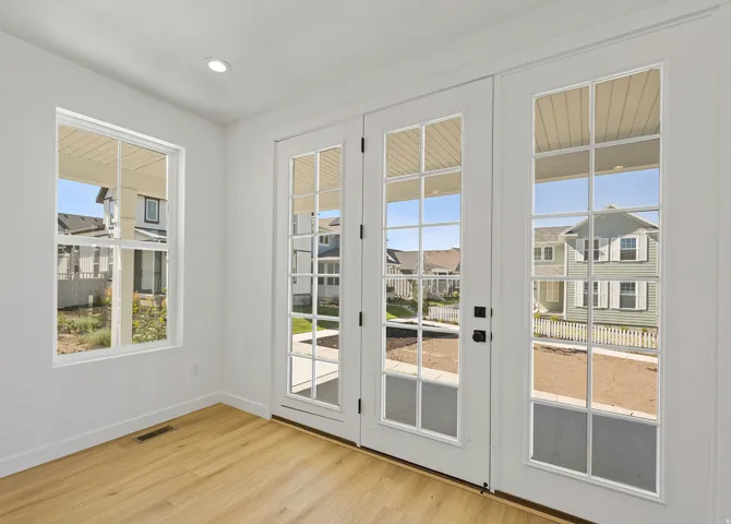 French doors with grid-pane windows, wood-finish flooring, white baseboards, a single-pane window, and recessed ceiling lighting
