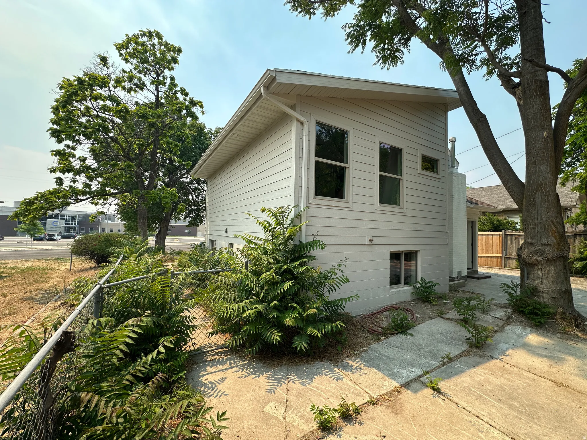 Exterior siding in a neutral tone with multiple windows providing natural light