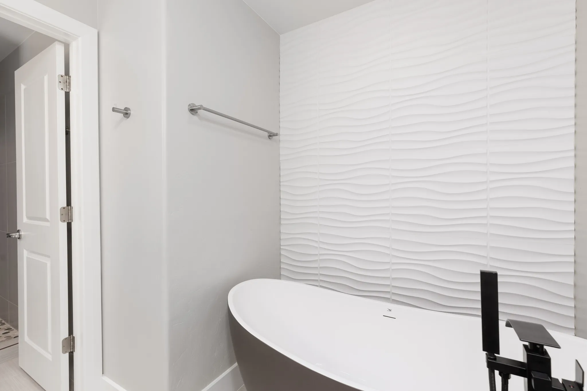 Freestanding soaking tub with matte black fixtures