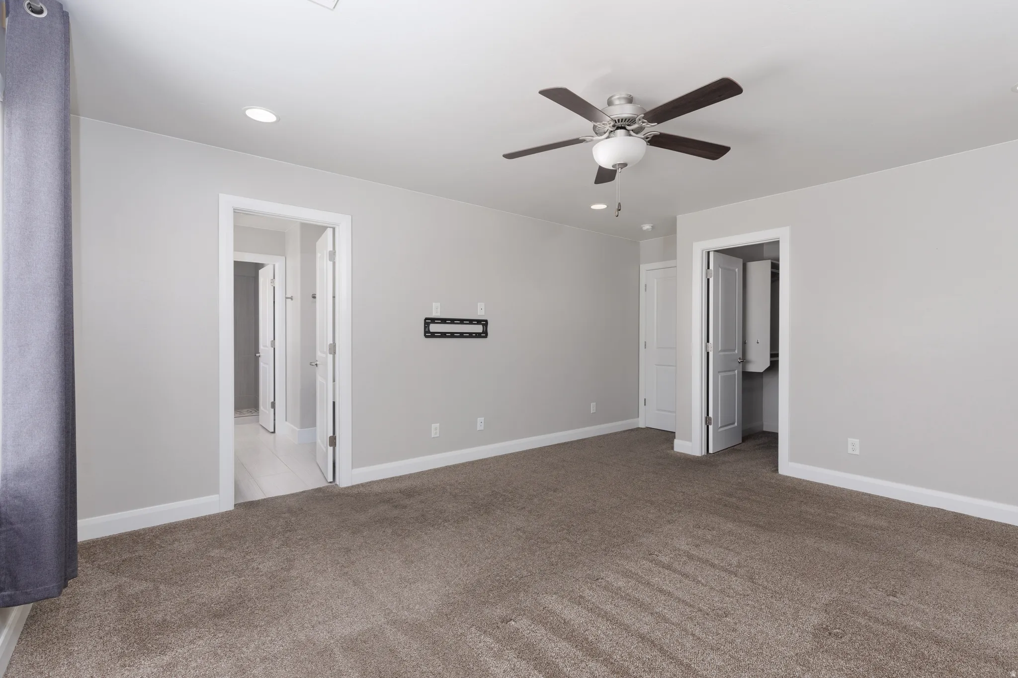 Carpeted room with light gray walls, recessed lighting, and a ceiling fan